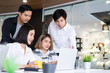 © PRIME STOCK LAB - Diverse startup young business people group working together on laptop at modern office.