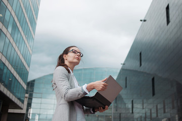 Career growth and ambitions, concept. Young businesswoman on the background of the business center.