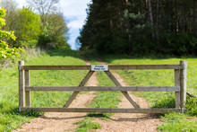 Private Farm Land Fenced Off By A Large Gate With A Private Keep Out Sign Showing No Access To The Rural Pathway