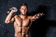 © Srdjan - Young strong sweaty focused crossfit muscular man with big muscles holding heavy kettle bell for training hard core workout in the gym