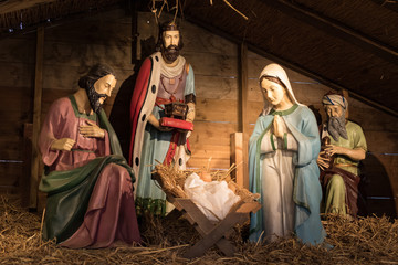 A traditional nativity scene with baby Jesus, Joseph and Mary and the wise men from the east who bring gifts.