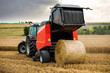 © Image'in - farmer in fields making straw bales