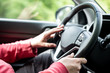 © Moon Safari - Man hand holding car steering wheel - Male hand close up shallow dof depth of field driving car - Two hands on steering wheel in traffic driving style background backdrop focus on steering wheel