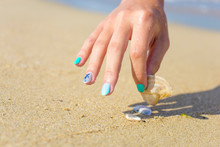 Marine Manicure With A Starfish Pattern. Composition In Blue With Shiny Nails. In The Background Image Sea, Ocean