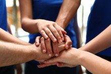 Group Of Volunteers Joining Hands Together, Closeup
