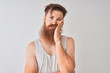 © Krakenimages.com - Young redhead irish man wearing t-shirt standing over isolated grey background thinking looking tired and bored with depression problems with crossed arms.