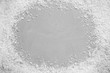 © New Africa - Frame of white snow on light grey stone background, top view with space for text. Christmas season