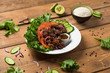 © lounom - Bo Luc Lac vietnamese beef salad. Also named Lok Lak in cambodia or Shaking Beef in America. Tasty marinated sauteed beef cubes are served with fresh lettuce, tomatoes, cucumbers, onions and rice.