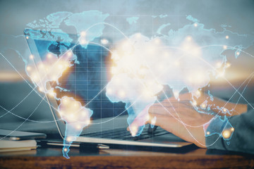 Fototapete - Multi exposure of businessman working on laptop on background. International business hologram in front. Concept of success.