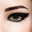 © Valua Vitaly - Closeup female eye with creative fashion make-up. brown eyeshadow