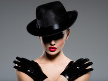 Сlose-up Portrait Of A Woman In A Black Hat And Gloves With Red Lips