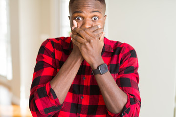 Canvas Print - Handsome african american man shocked covering mouth with hands for mistake. Secret concept.