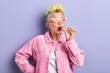 © alfa27 - funny woman with dyed yellow hairstyle enjoying eating sweets, sweet tooth, happiness, favourite candy