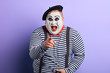 © alfa27 - laughing crazy plump mime with wide open mouth points with finger at you, happiness, emotion and feeling. close up portrait, isolated blue background, studio shot