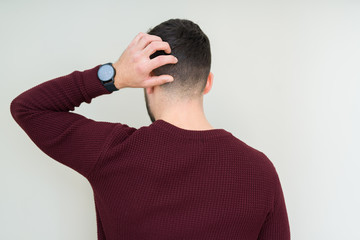 Sticker - Young handsome man wearing a sweater over isolated background Backwards thinking about doubt with hand on head