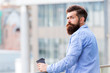 © be free - Set up for new day. Guy bearded hipster enjoying coffee alone. Man drink take away coffee outdoors urban background. Daily rituals. Morning coffee concept. Caffeine energy charge. Personal efficiency