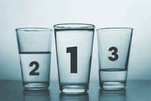 Three Glasses With Different Amount Of Water And Rank Numbers Like Medals Podium - Conceptual Style
