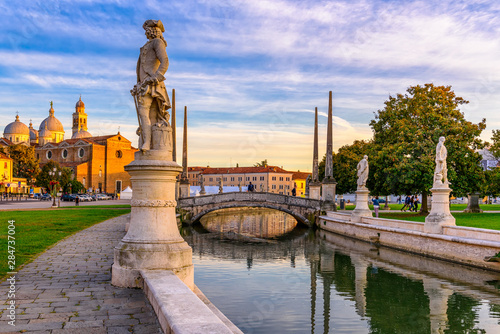 View of canal with statues on square Prato della Valle and Basilica Santa Giu...