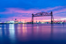 Vertical Lift Bridge For Railroad Over The Elizabeth River On The Border Of Norfolk And Chesapeake Virginia Against A Beautiful Red, Purple, Pink, And Blue Sunset