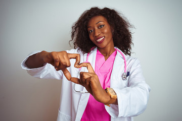 african american doctor woman wearing pink stethoscope over isolated white background smiling in lov