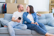 © Krakenimages.com - Young couple sitting on the sofa at new home using smartphone, hugging and smiling happy for moving to a new apartment