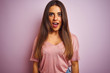© Krakenimages.com - Young beautiful woman wearing t-shirt standing over isolated pink background afraid and shocked with surprise expression, fear and excited face.