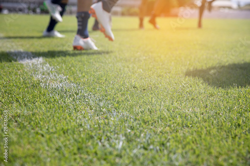 blur football players training warm up on green field Tablou Canvas