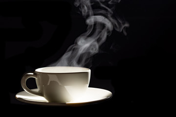 Wall Mural - cup of coffee with steam on black background