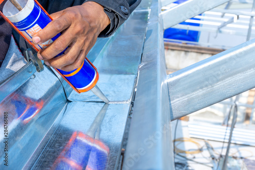 Technician Man Hand Holding Glue Gun With Silicone Adhesive Or Manual Caulking Gun With Polyurethane To Repair And Fix The Metal Steel Installation And Renovation Concept Buy This Stock Photo And