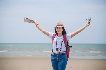 Wall Mural - Traveling people concept. Young happy asian gril at the beach