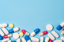 Studio Shot Of Medical Pills On Blue Background