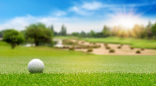 White Golf Ball On Green Course To Be Shot On Blurred Beautiful Landscape Of Golf Course In Bright Day Time With Copy Space. Sport, Recreation, Relax In Holiday Concept	