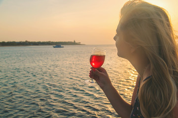 Wall Mural - Drink wine by the sea. Selective focus.