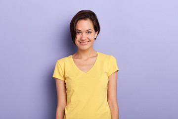 cheerful smiling girl with short black hair showing her white teeth to camera while feeling happy and carefree. close up portrait, beauty concept.