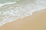 Fototapeta Morze - Soft wave at the sea on the sandy beach. Background