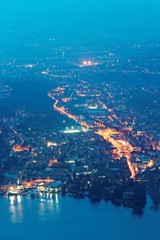 Wall Mural - Aerial view of Cernobbio and Tavernola, two beautiful lakeside villages by Como Lake, from viewpoint near Brunate at misty dusk, in Lombardy, Northern Italy