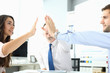 Portrait of smart businesspeople reaching arms performing special friendly gesture to show happy attitude to work and collective. Biz meeting concept. Blurred background