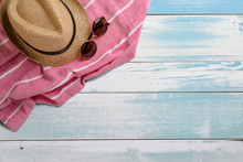Towel. Scarf. Cover For Picnic. Sunglasses. Straw Hat. Summer Travel Concept Elements. On Turquoise Wooden Table. Top View.