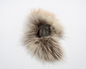 Norse rune Uruz, isolated on fur and white background. Health, strength, masculinity. The energy of the earth.