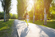 © fotofabrika - Sporty young woman in sportswear running in the park in the morning