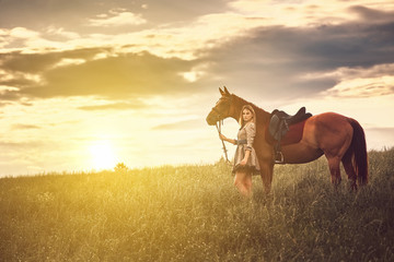 Wall Mural - Beautiful girl with a horse in the field.