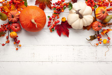 Festive Autumn Decor From Pumpkins, Berries And Leaves On A White  Wooden Background. Concept Of Thanksgiving Day Or Halloween. Flat Lay Autumn Composition With Copy Space.