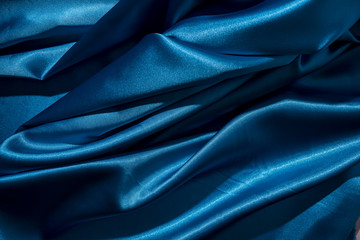 background image of crumpled fabric. blue silk