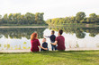 © satura_ - Parenthood, nature, people concept - family with two sons sitting near the lake