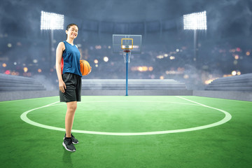 Wall Mural - Asian woman basketball player holding the ball