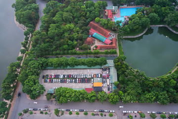 Aerial view of Hanoi city, Vietnam. Hanoi cityscape by sunset period at Linh Dam peninsula, with green trees and car parking