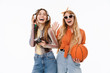 © Drobot Dean - Portrait of two pretty girls laughing while holding basketball and retro camera