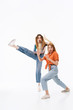 © Drobot Dean - Portrait of two young girls wearing casual clothes screaming and doing karate gestures