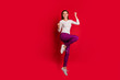 © deagreez - Full length body size photo of nice cute charming fascinating beautiful girlfriend jumping joyfully celebrating her victory while isolated with red background