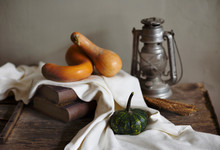 Autumn Still Life With Vintage Lantern And Pumpkin Vegetable On Rustic Wooden Table.
